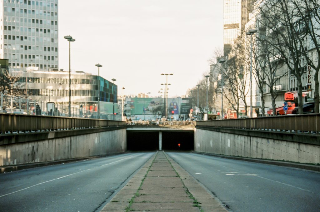 gray concrete road near city buildings during daytime