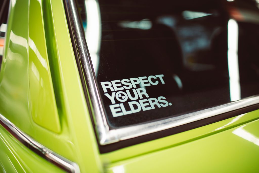 respect your elders sign on car window