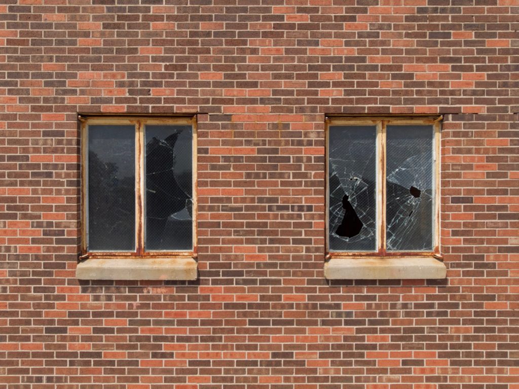 two broken glass building windows