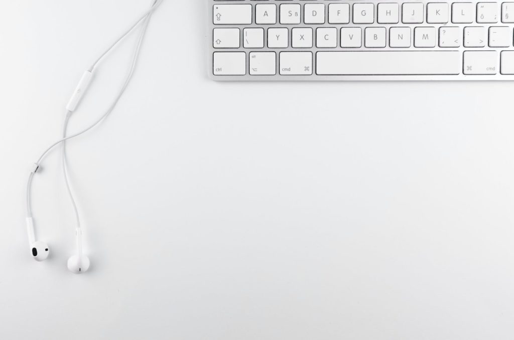 top view photo of keyboard near earphone