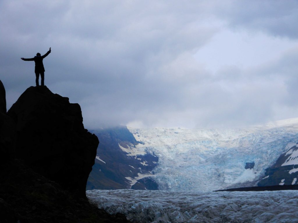 silhouette of a person on top of rock living his life on his terms