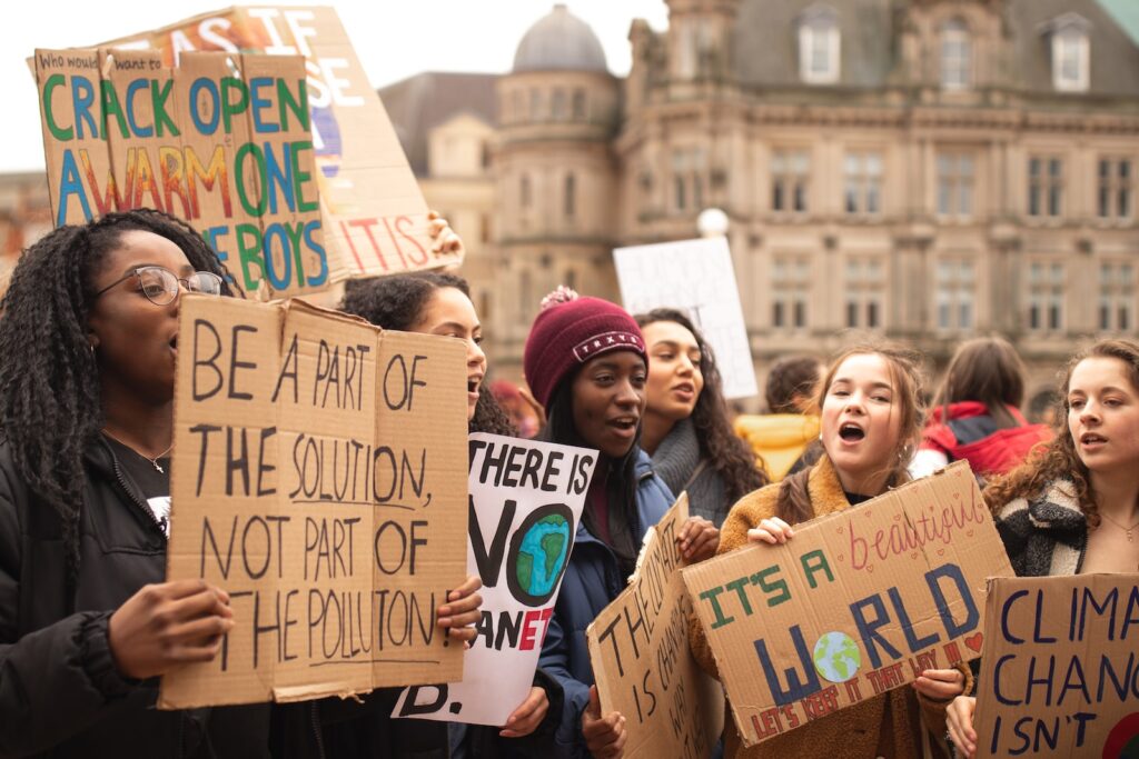 women holding signs during daytime