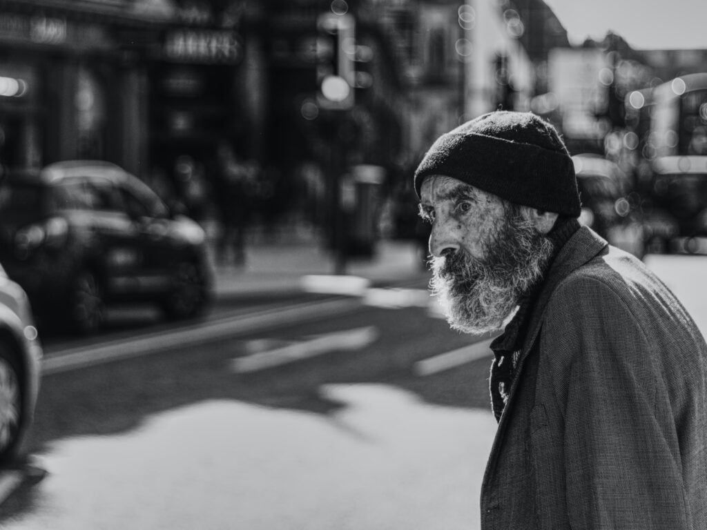 man beside the road with cars