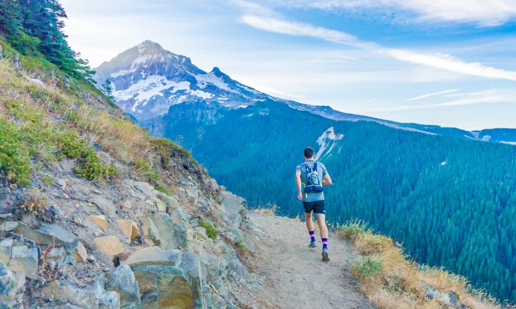 man running on edge near mountain Are you on the same self-improvement journey?